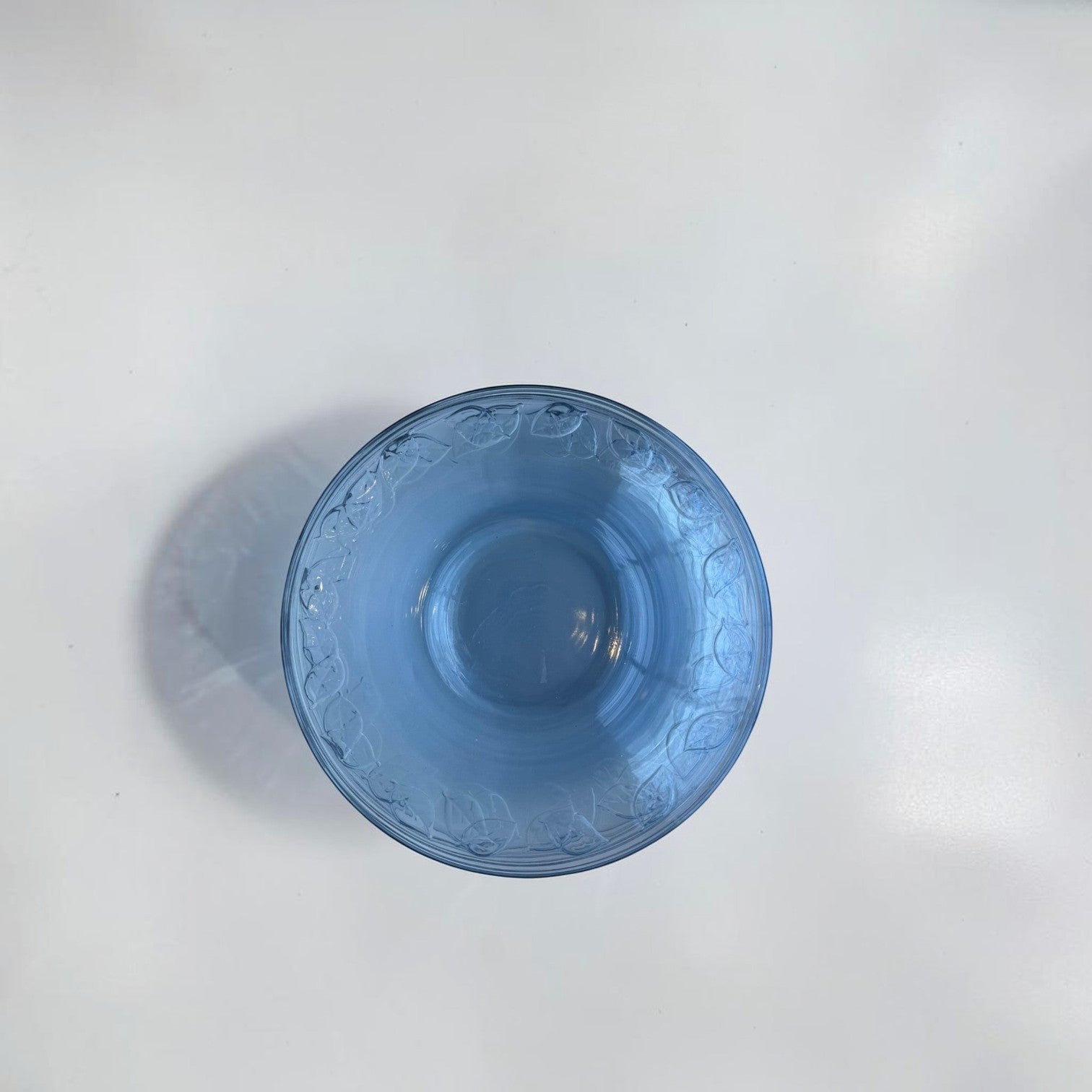 Her Good Eye blue glass serving bowl with embossed leaf pattern around the rim, perfect for salads or as a centerpiece.
