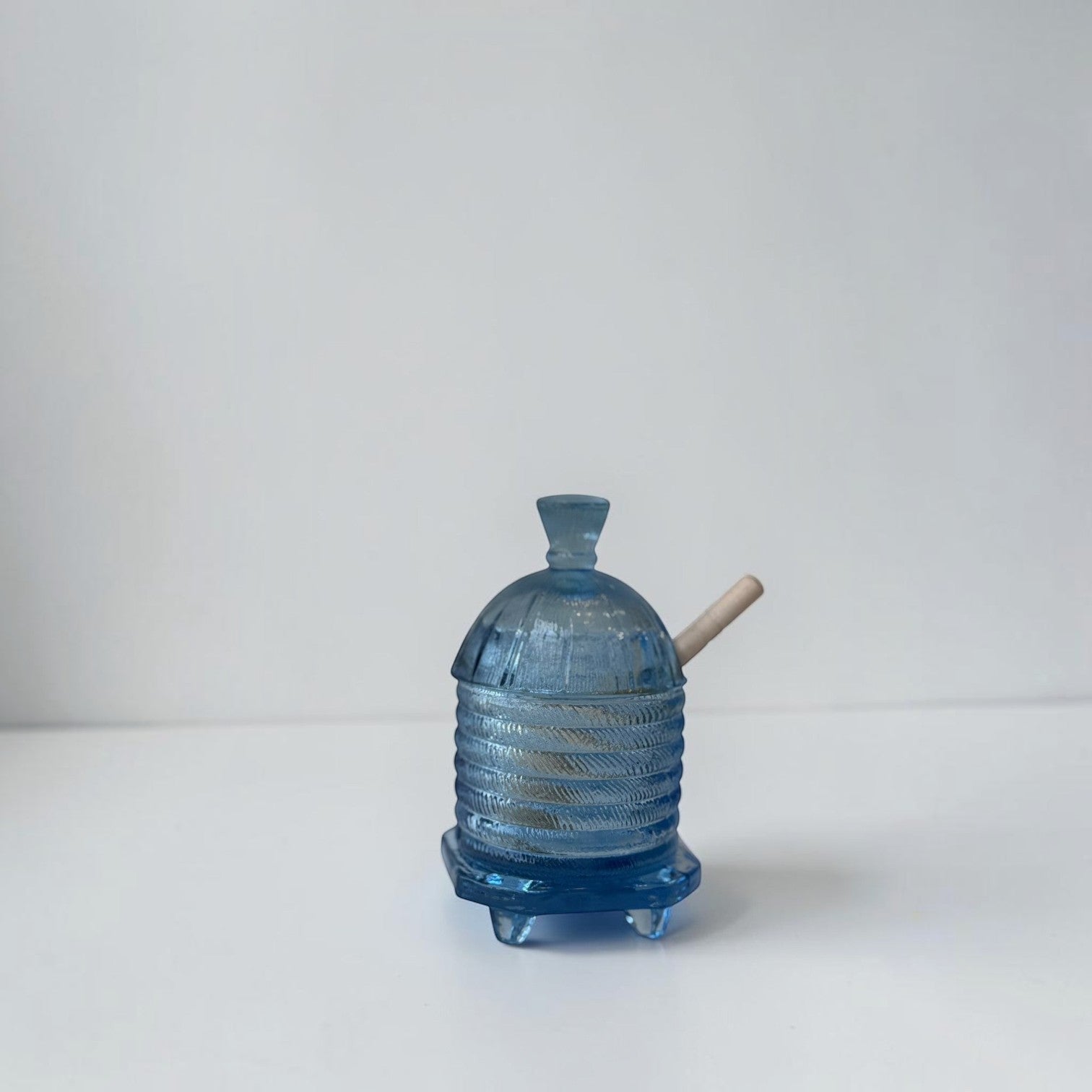 Her Good Eye blue glass water pipe with ribbed beehive design and dipper. Features a stable base with four feet.