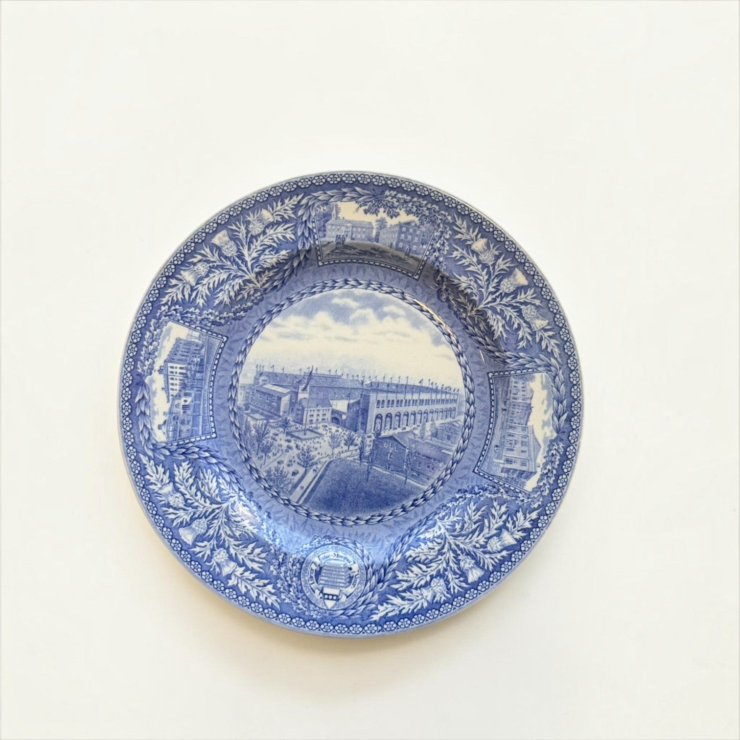Her Good Eye vintage blue and white ceramic collector plate featuring a historic stadium illustration and botanical border