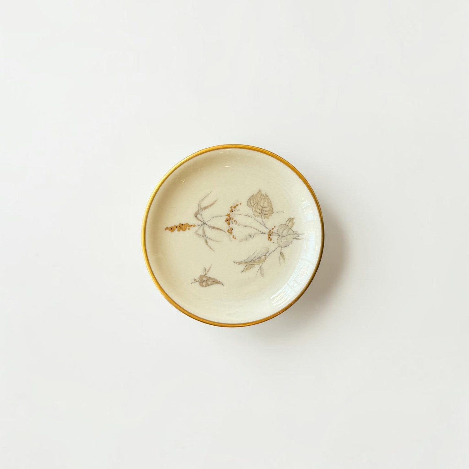 Her Good Eye cream porcelain trinket dish with hand-painted botanical motif and gold-tone rim on white background