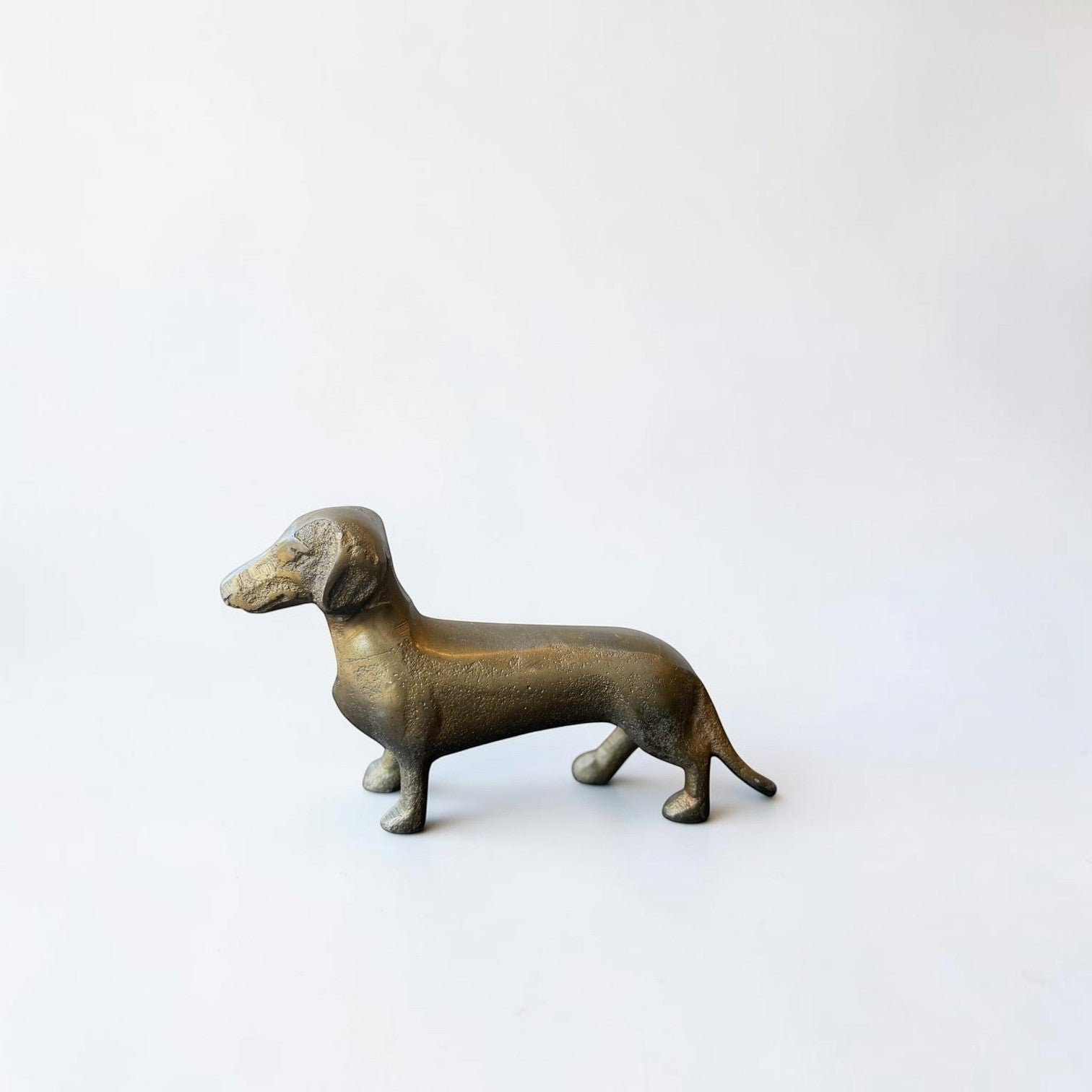 Her Good Eye antique brass dachshund dog figurine sculpture with detailed features and a classic silhouette.
