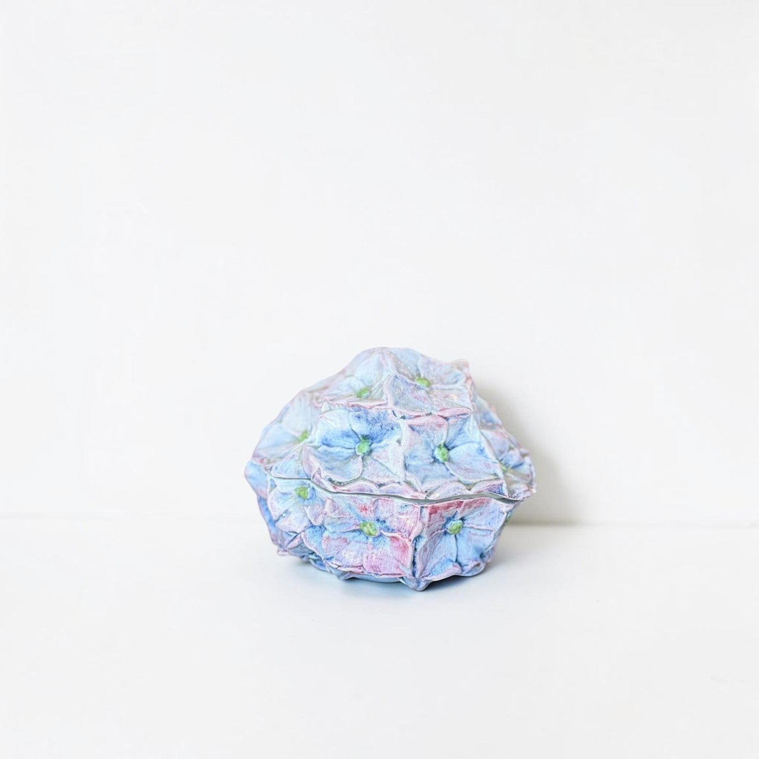 Her Good Eye handcrafted ceramic hydrangea trinket box in pastel blue and pink with intricate petal detailing.