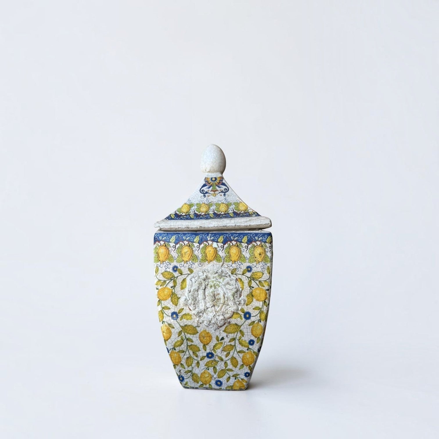 Her Good Eye decorative ceramic lidded jar with hand-painted yellow lemons, blue flowers, and vintage crackle glaze.
