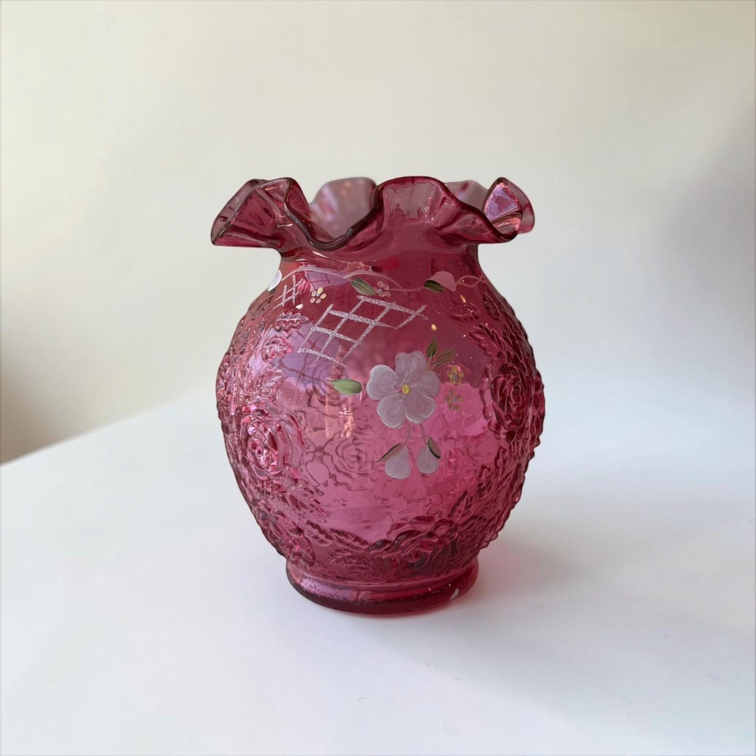 Her Good Eye cranberry glass hobnail vase with hand-painted purple flowers and ruffled rim.