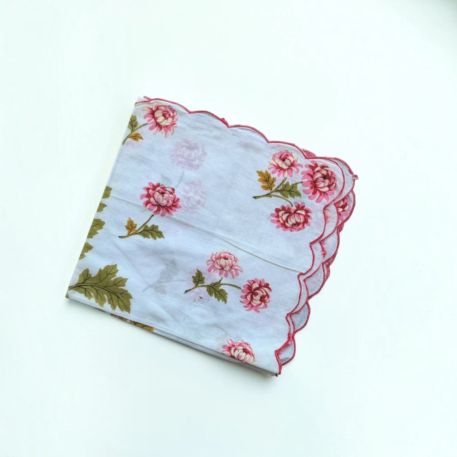 Her Good Eye vintage cotton handkerchief with pink chrysanthemum floral print, green leaves, and scalloped pink edges.