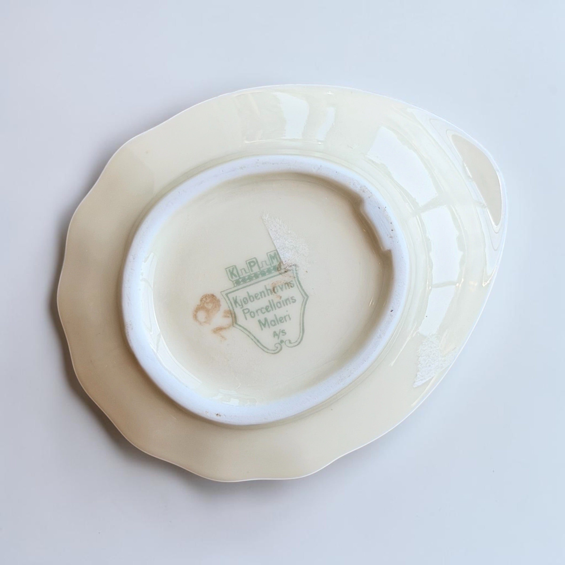 Her Good Eye floral gilded porcelain trinket dish with scalloped gold rim and pink, purple, blue, brown floral bouquet.