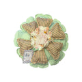 Her Good Eye handcrafted flower throw pillow with mint green geometric petals, earth-toned polka dots, and lace center.