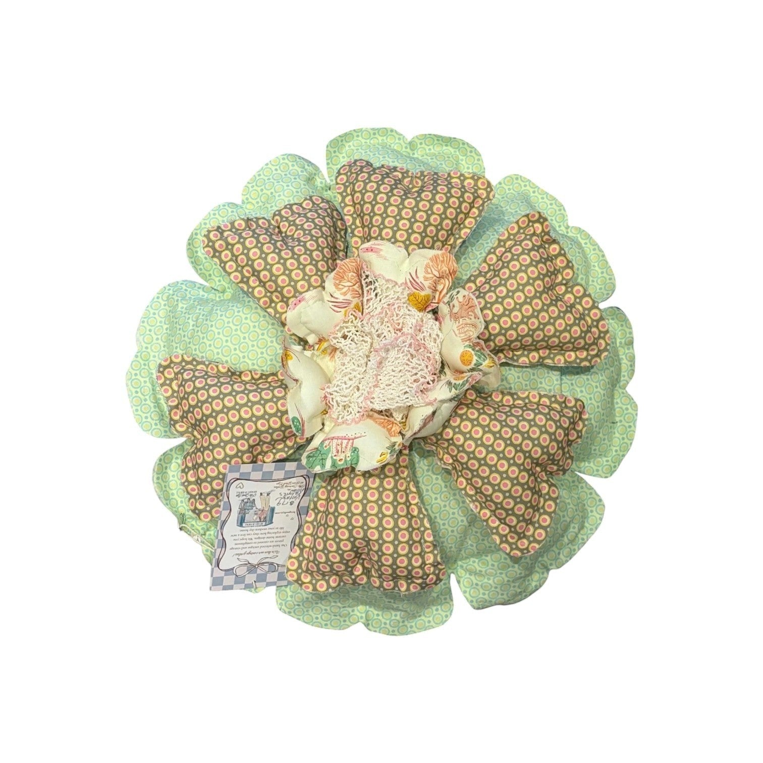 Her Good Eye handcrafted flower throw pillow with mint green geometric petals, earth-toned polka dots, and lace center.