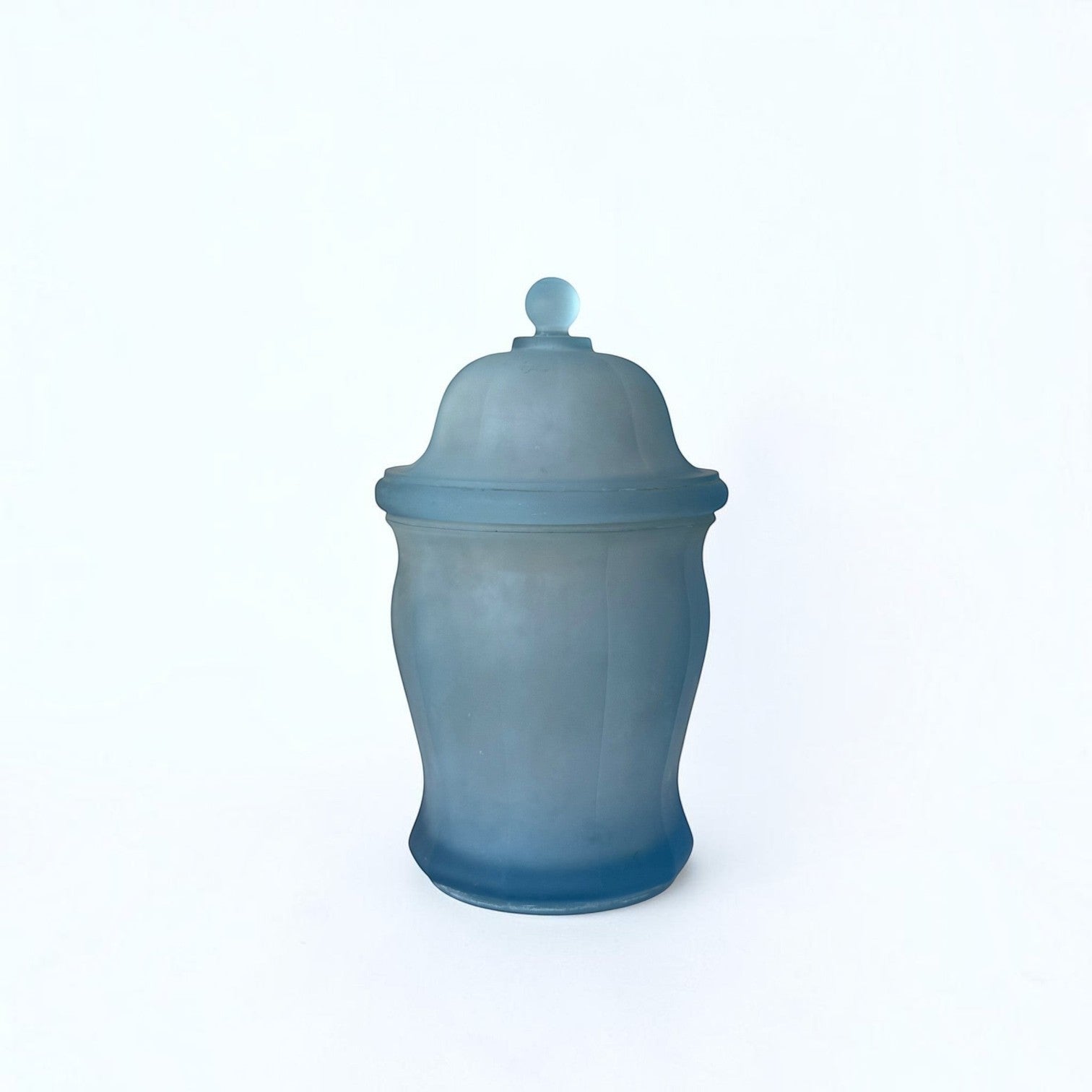 Her Good Eye frosted blue glass apothecary jar with a matching lid and spherical finial for home decor.