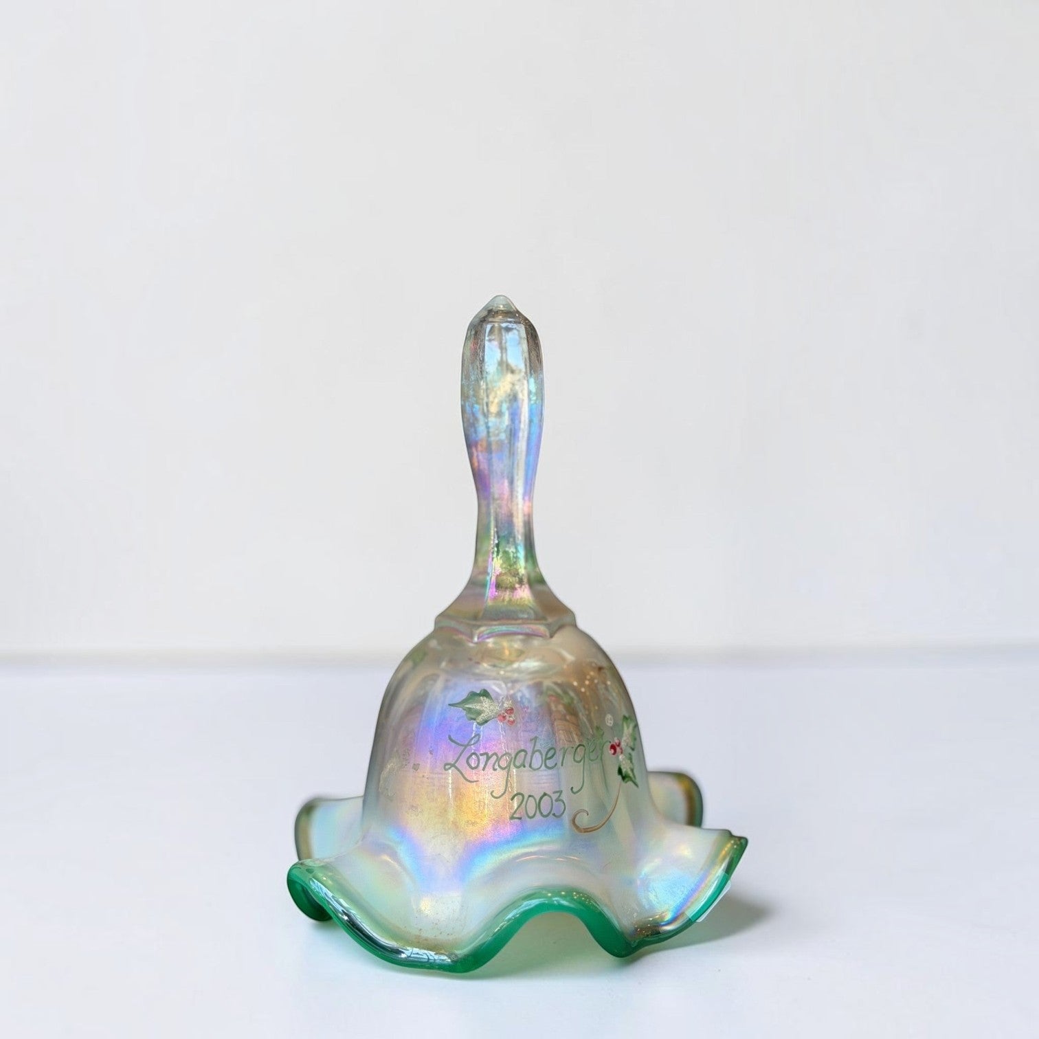 Her Good Eye 2003 Longaberger iridescent glass bell ornament with hand-painted holly and ruffled green-tinted base.