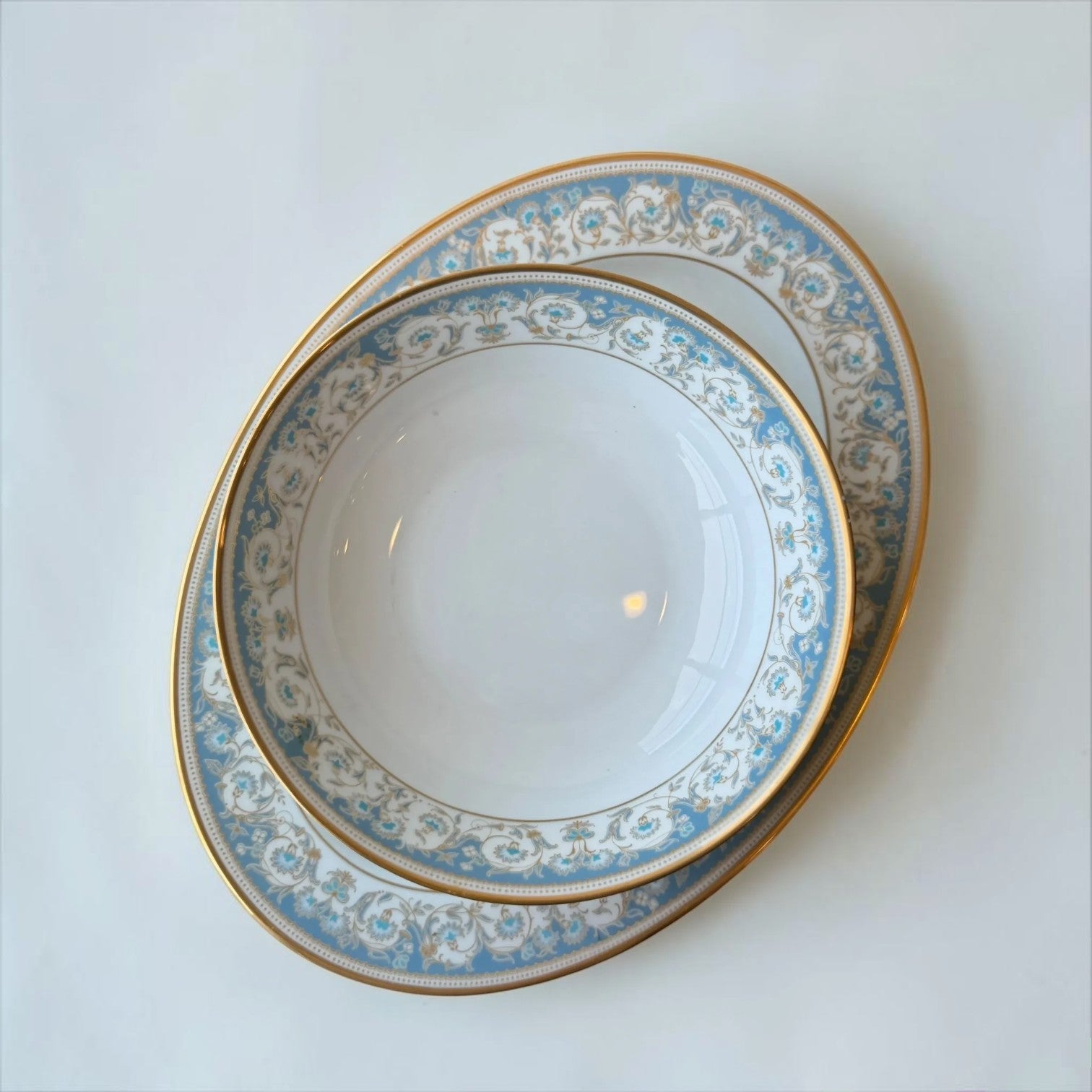 Her Good Eye decorative porcelain serving bowl with blue floral pattern and gold rim. Ideal for serving dishes.