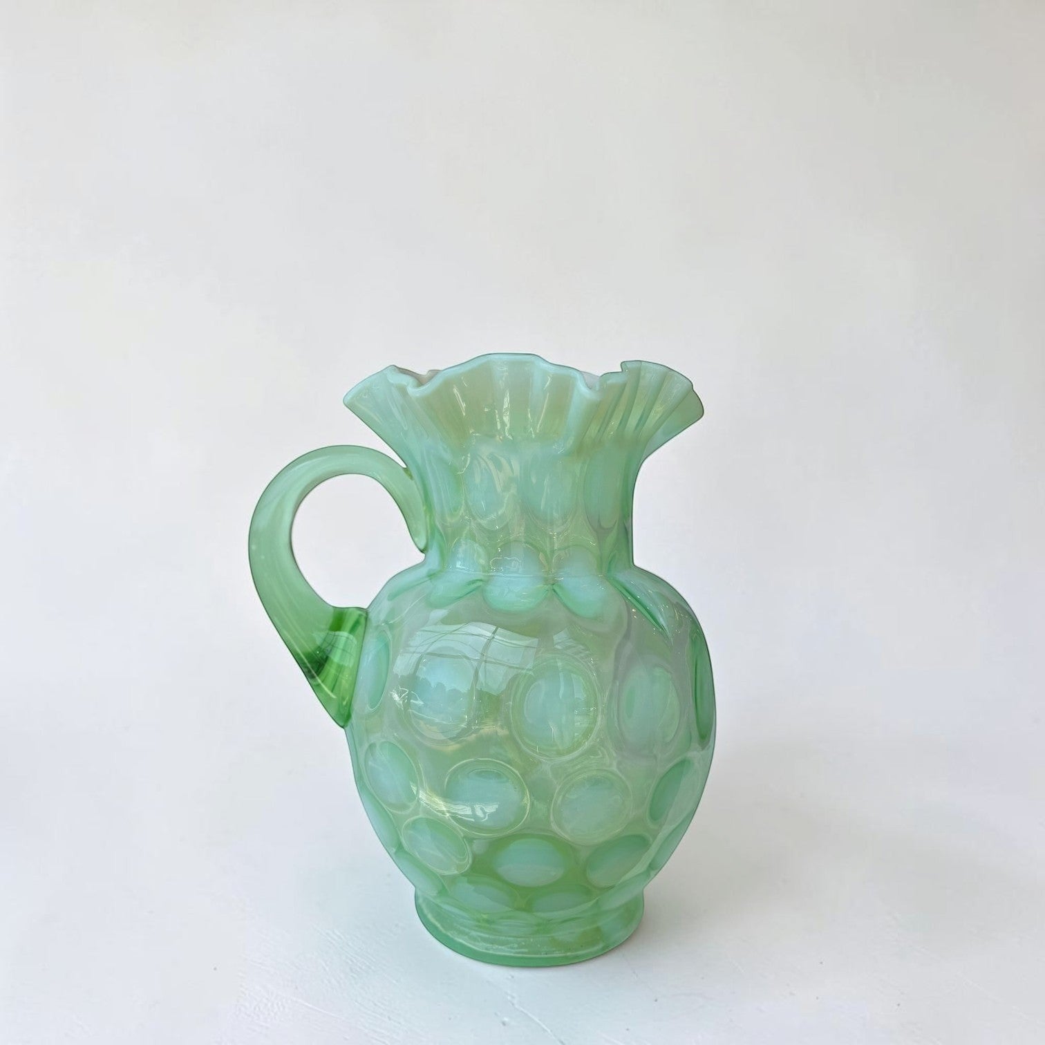 Her Good Eye seafoam green hobnail glass pitcher with ruffled rim and matching tumblers.