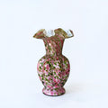 Her Good Eye hand blown glass vase with pink and green speckled pattern, ruffled rim, and ribbed bulbous silhouette.