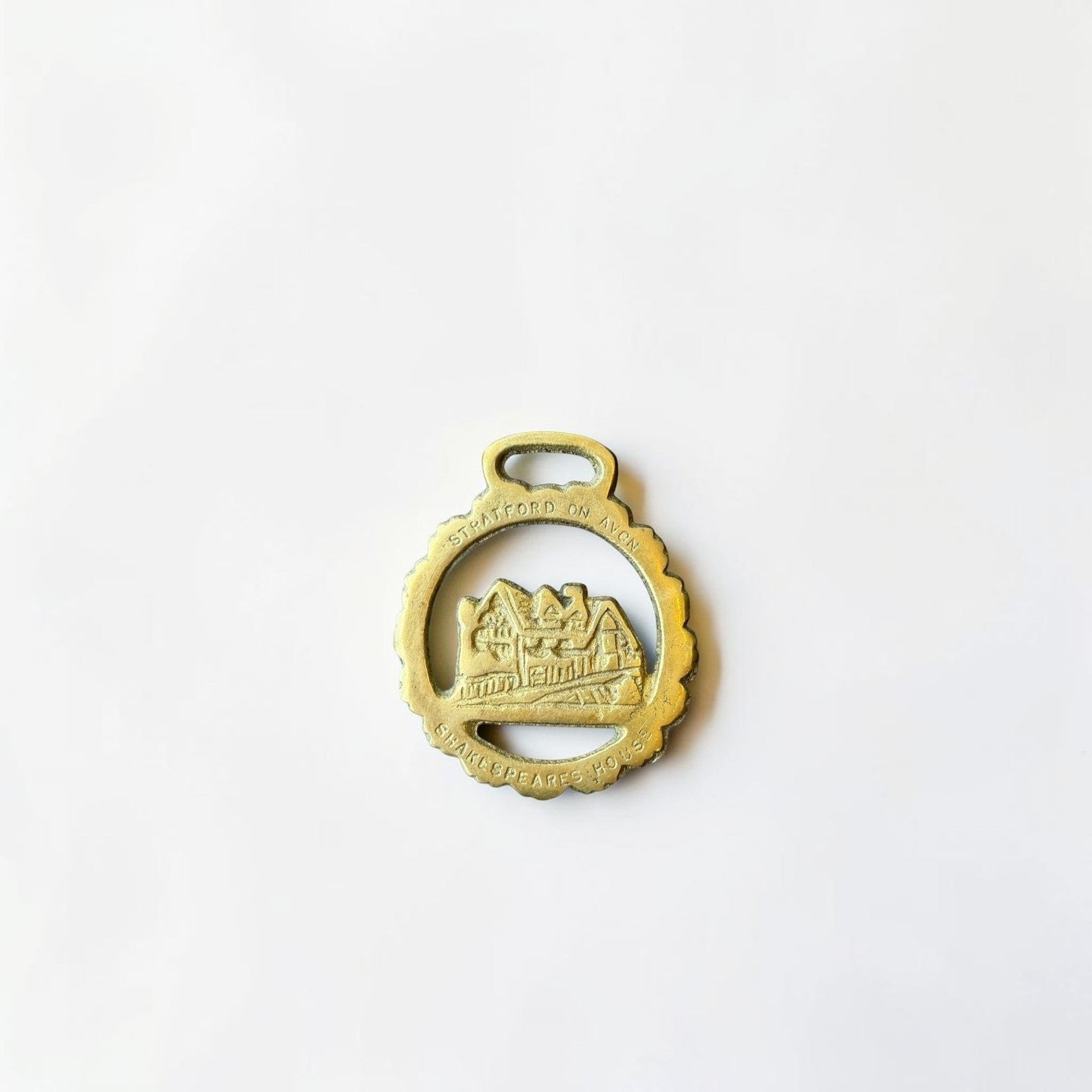 Her Good Eye Stratford-upon-Avon Shakespeare's House brass souvenir charm with scalloped edge and hanging loop.