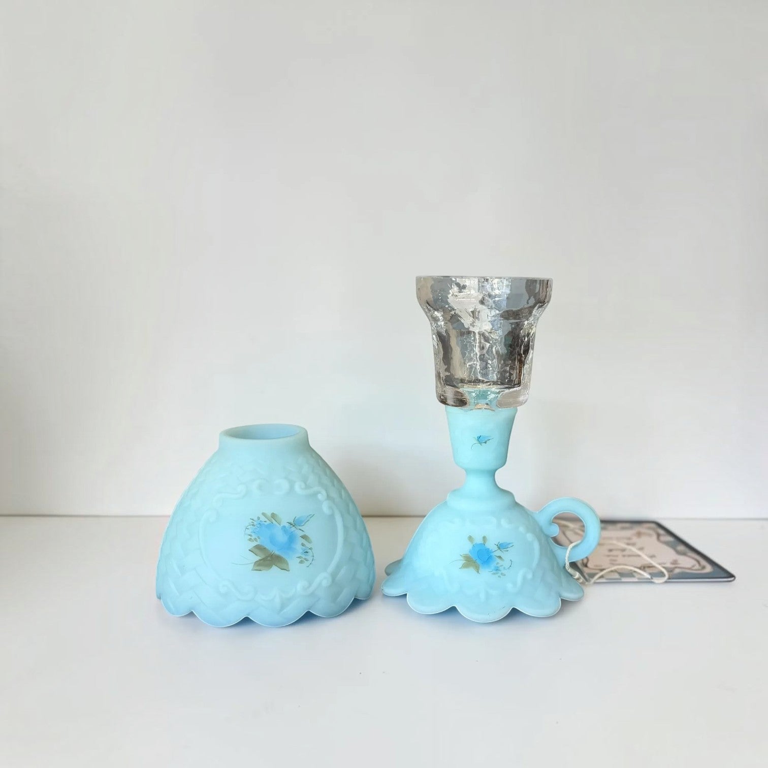 Her Good Eye vintage blue satin glass table lamp with hand-painted floral details and a scalloped base design.