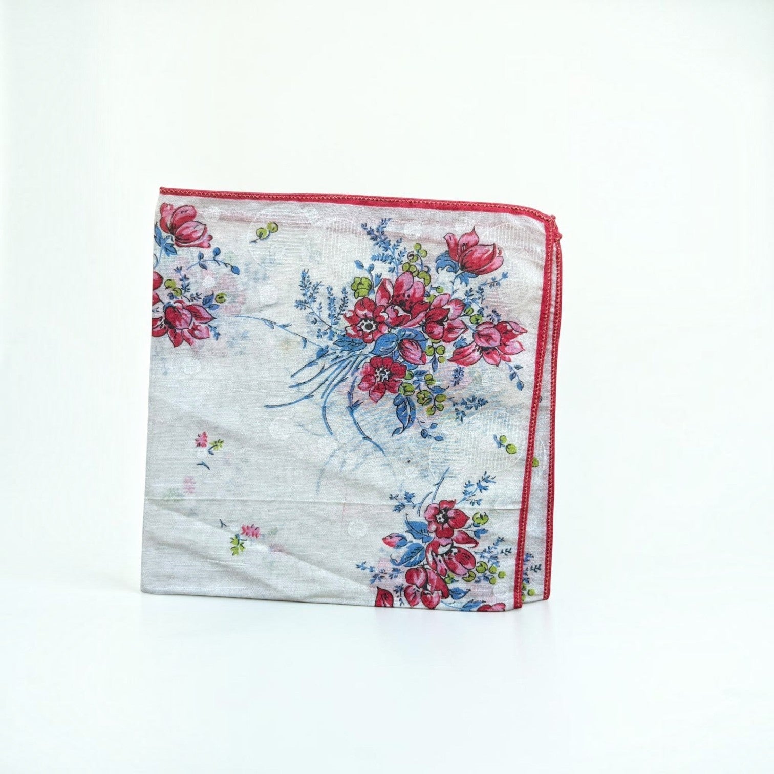 Her Good Eye vintage cotton handkerchief with pink and red floral print, blue foliage, and red stitched edges.
