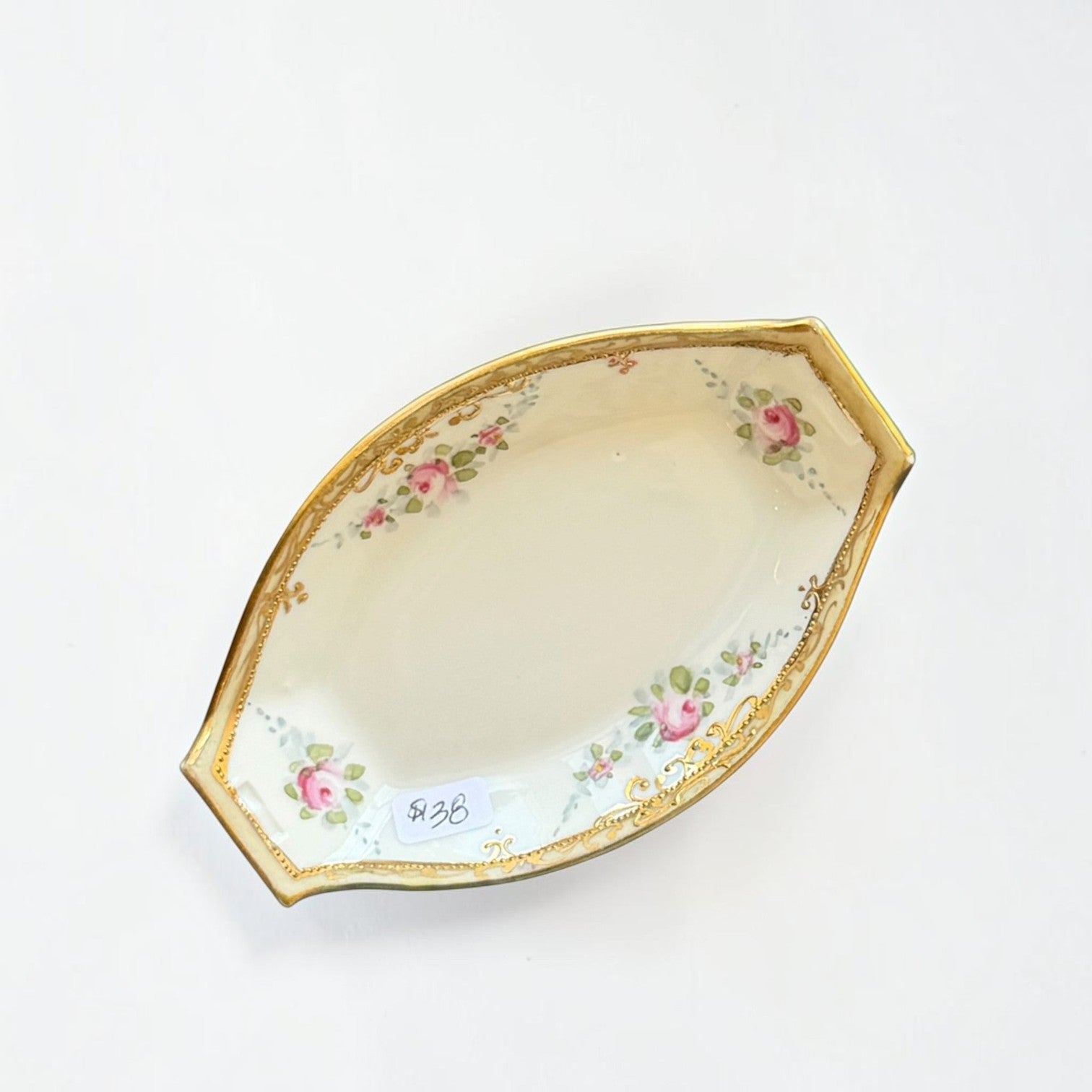 Her Good Eye vintage porcelain serving dish with pink rose floral pattern, green foliage, and gold gilded rim.