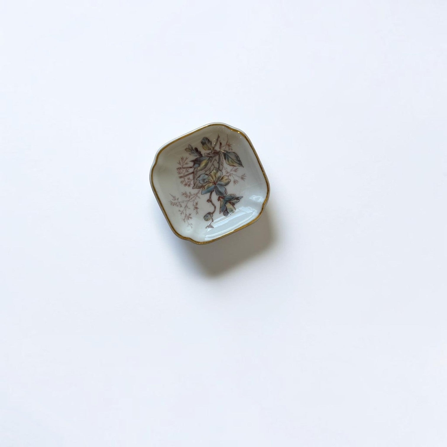 Her Good Eye vintage porcelain trinket dish with hand-painted floral motif, scalloped edges, and gold-tone trim.